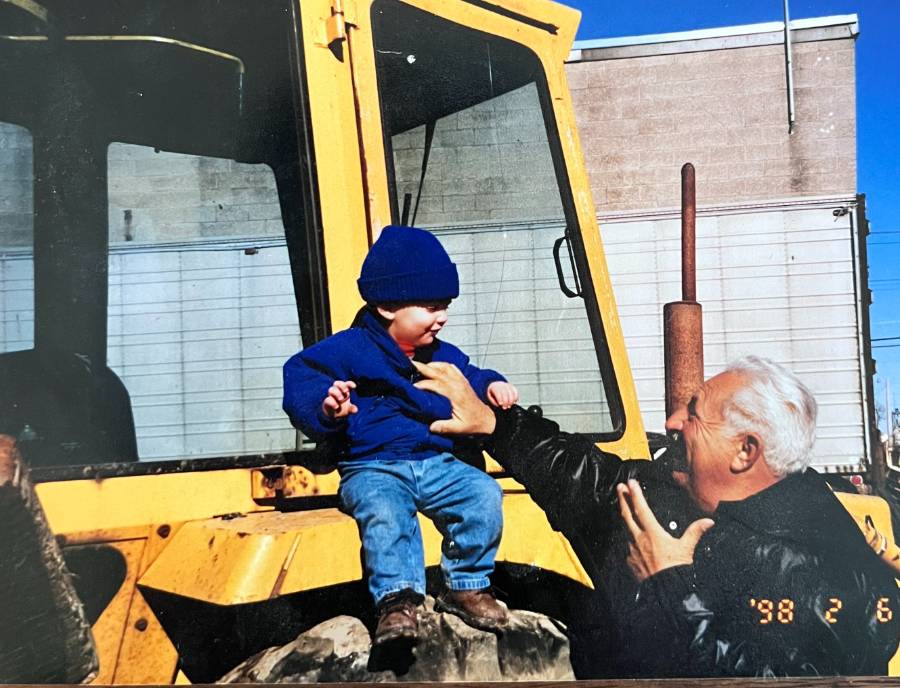 Scott West as a toddler sitting on his grandfather's Cimato Bros. tractor, held by his grandfather